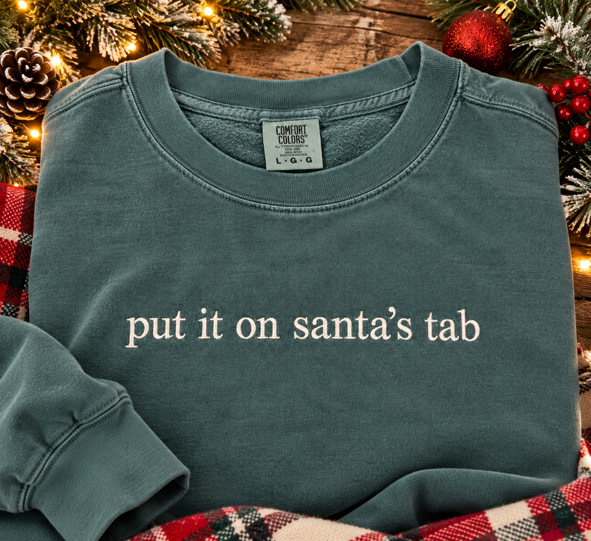 Put It on Santa’s Tab Embroidered Sweatshirt & Tee